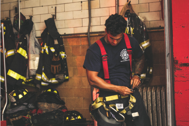 A Firefighter putting on his uniform